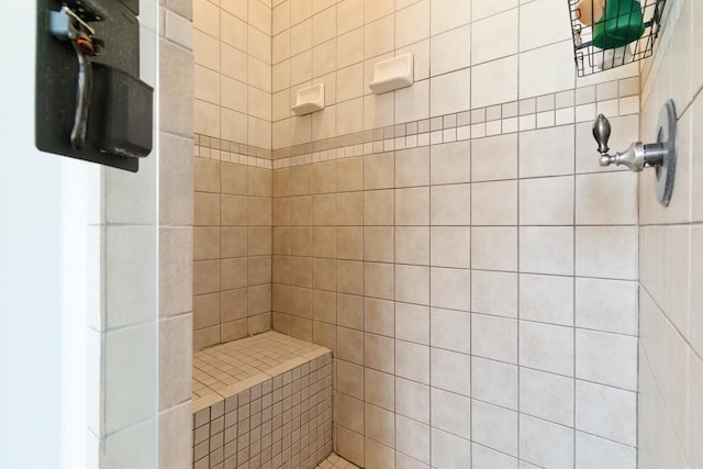 bathroom with a tile shower