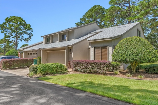 view of front of property with a garage and a front lawn