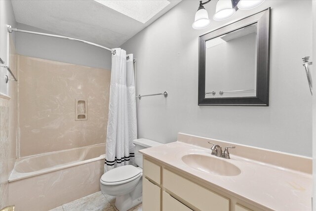 full bathroom featuring toilet, tile patterned floors, vanity, a textured ceiling, and shower / bath combo with shower curtain