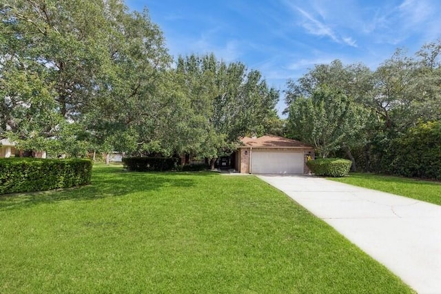 view of front of home with a garage and a front lawn