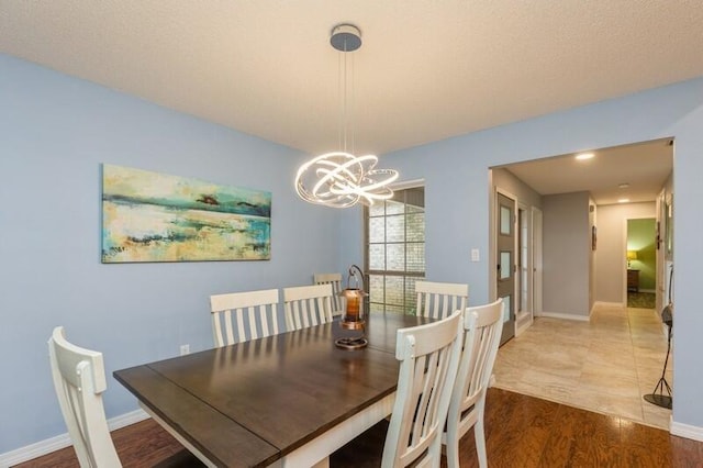 dining area with an inviting chandelier and hardwood / wood-style floors