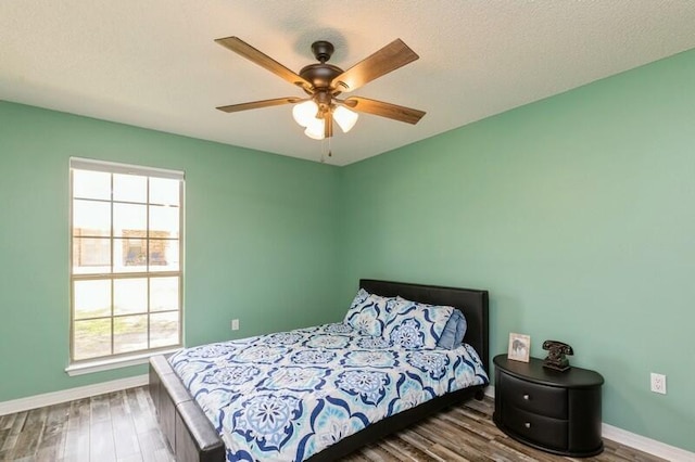 bedroom featuring ceiling fan and dark hardwood / wood-style floors