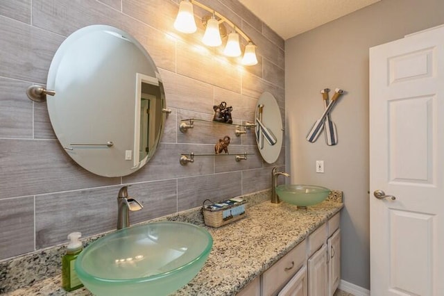 bathroom featuring vanity, backsplash, and tile walls