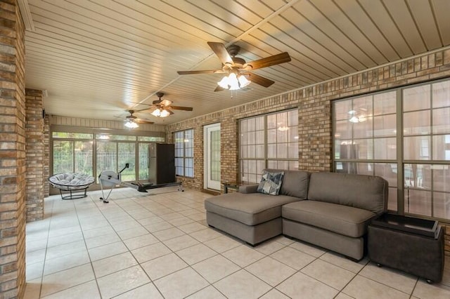 unfurnished sunroom featuring wood ceiling and ceiling fan