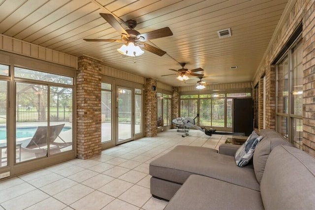 unfurnished sunroom featuring wood ceiling and ceiling fan