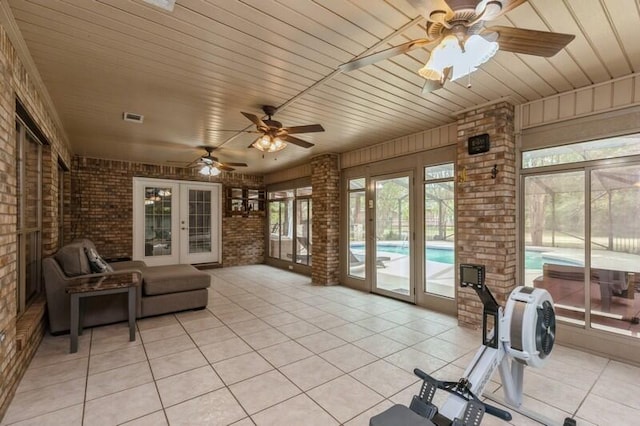 sunroom featuring wood ceiling, french doors, and ceiling fan