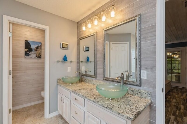 bathroom featuring vanity, toilet, and hardwood / wood-style flooring