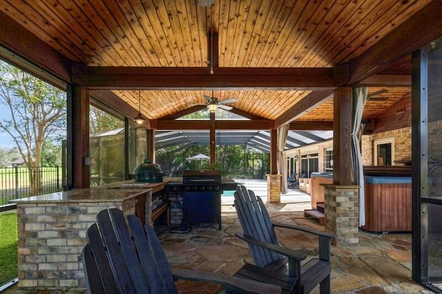 view of patio featuring area for grilling, ceiling fan, and a grill