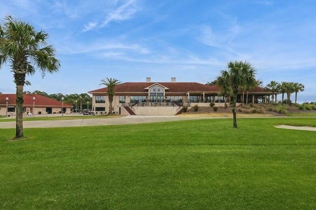 view of property's community with a lawn