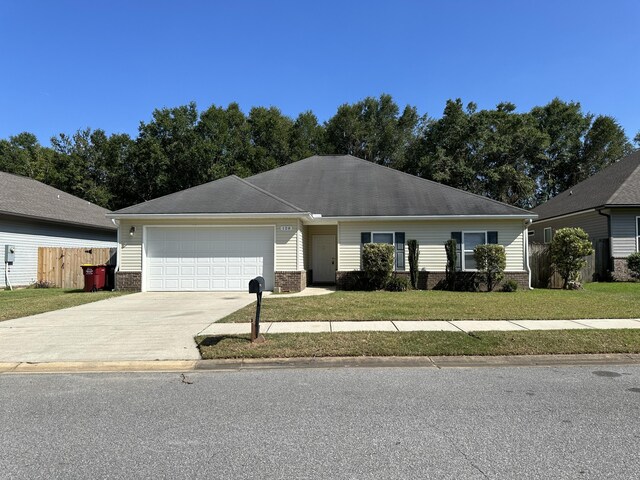 ranch-style house featuring a front lawn and a garage