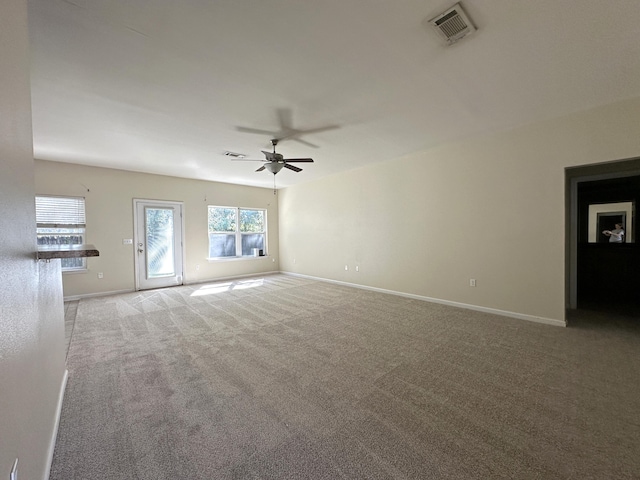 unfurnished living room featuring light carpet and ceiling fan