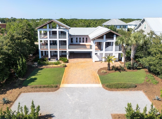 view of front of property featuring a front yard and decorative driveway