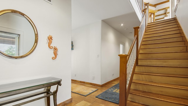 staircase featuring baseboards