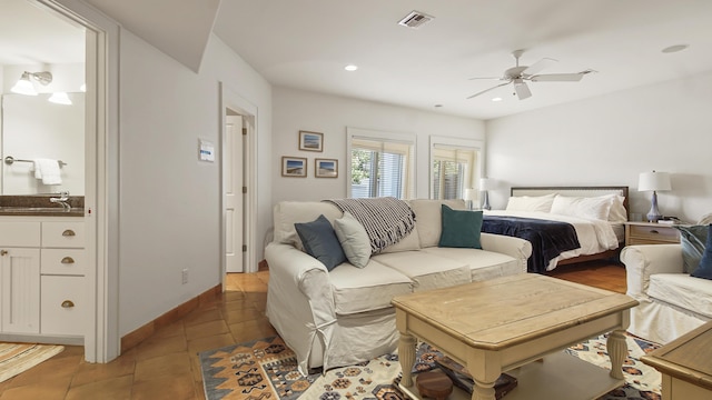 bedroom with recessed lighting, visible vents, connected bathroom, baseboards, and tile patterned floors