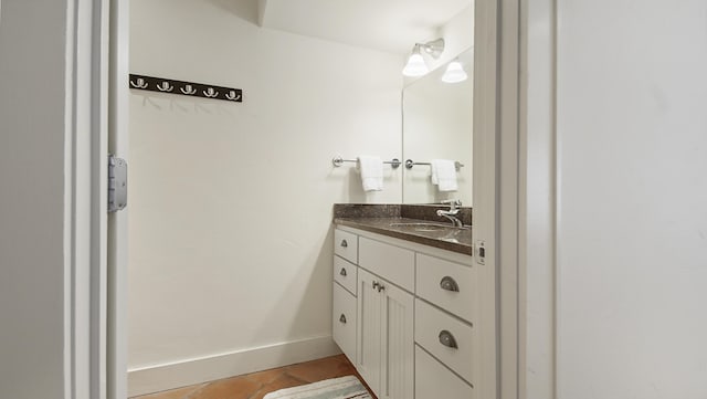 bathroom featuring baseboards and vanity