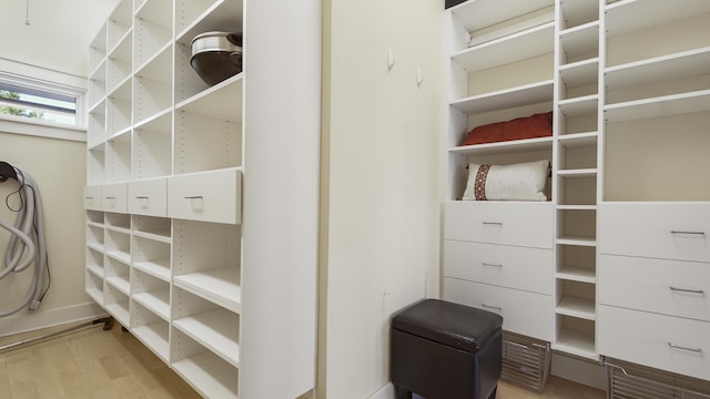 walk in closet with light wood-type flooring