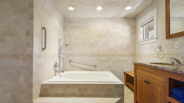 full bathroom featuring recessed lighting, tile walls, and vanity