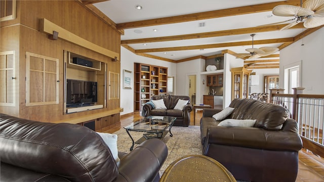 living room with ceiling fan, visible vents, built in features, tile patterned floors, and beamed ceiling