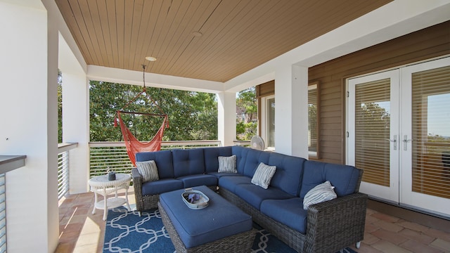 sunroom / solarium featuring french doors and wooden ceiling