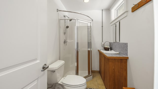 bathroom with toilet, a stall shower, decorative backsplash, and tile patterned floors