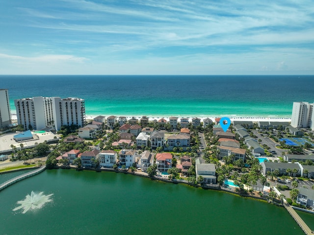 birds eye view of property with a water view and a view of the beach