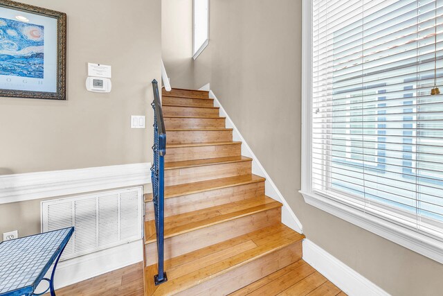 stairs featuring wood-type flooring