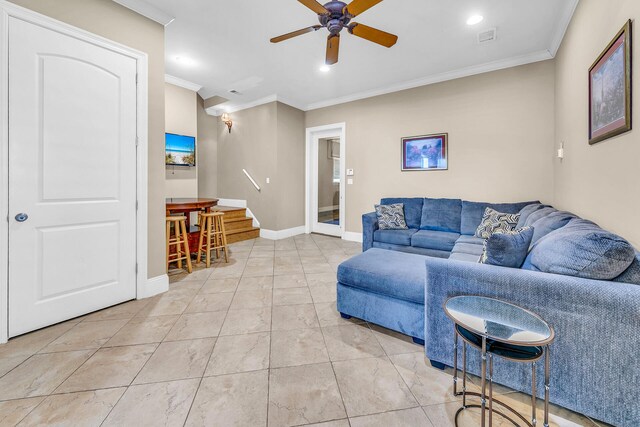 tiled living room with crown molding and ceiling fan