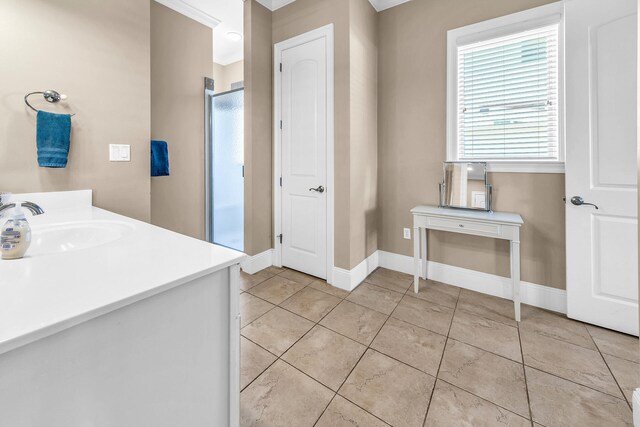 bathroom with tile patterned flooring, vanity, and an enclosed shower