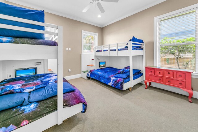 bedroom featuring crown molding, carpet flooring, and ceiling fan