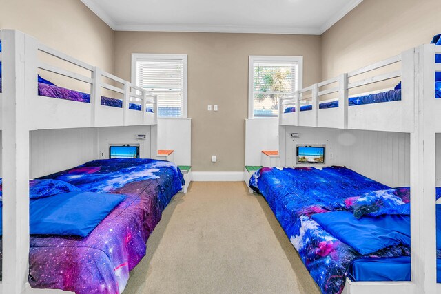 bedroom with ornamental molding and carpet floors