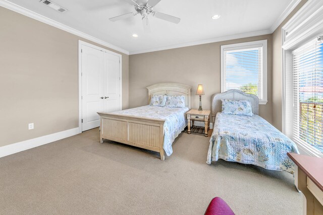 carpeted bedroom featuring ceiling fan, ornamental molding, and a closet