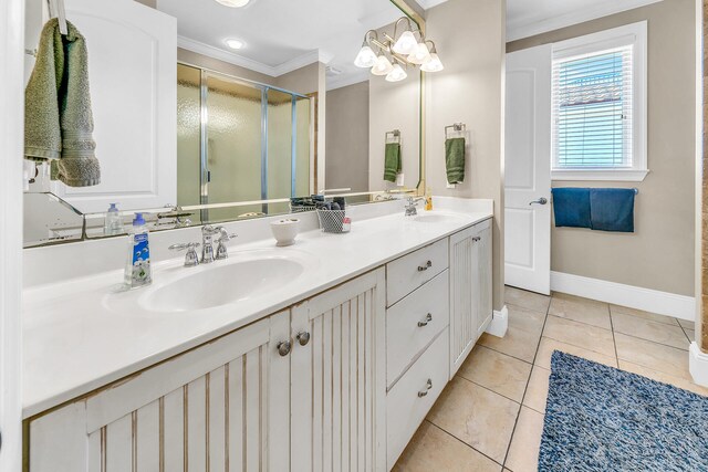 bathroom with crown molding, vanity, a shower with shower door, and tile patterned floors