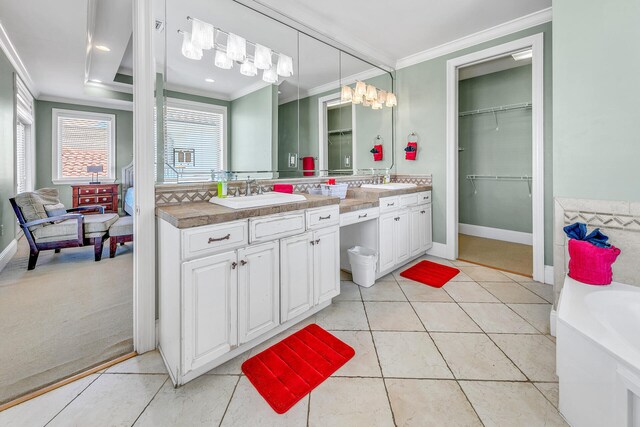 bathroom with tile patterned flooring, ornamental molding, and vanity