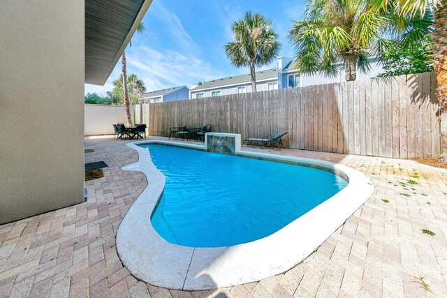 view of pool with pool water feature and a patio area