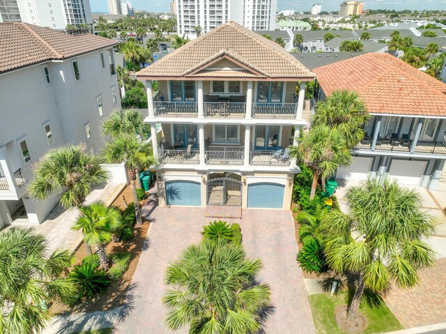 back of property with a garage and a balcony