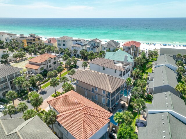 drone / aerial view featuring a water view and a view of the beach