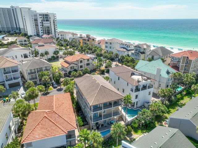 drone / aerial view featuring a water view and a beach view