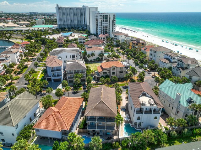 birds eye view of property featuring a beach view and a water view