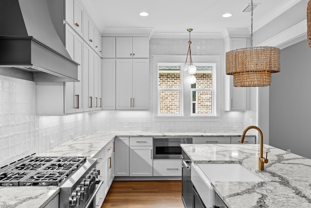 kitchen with white cabinets, custom exhaust hood, decorative backsplash, and stainless steel appliances