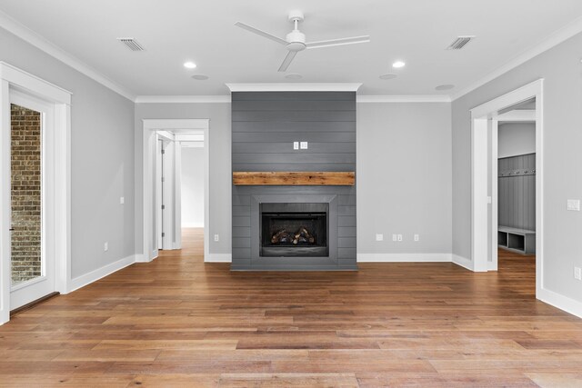 unfurnished living room featuring a fireplace, ceiling fan, light hardwood / wood-style flooring, and crown molding