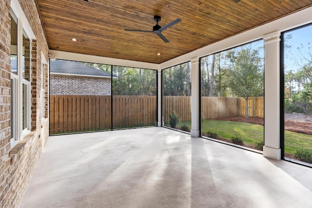 unfurnished sunroom with ceiling fan and wood ceiling