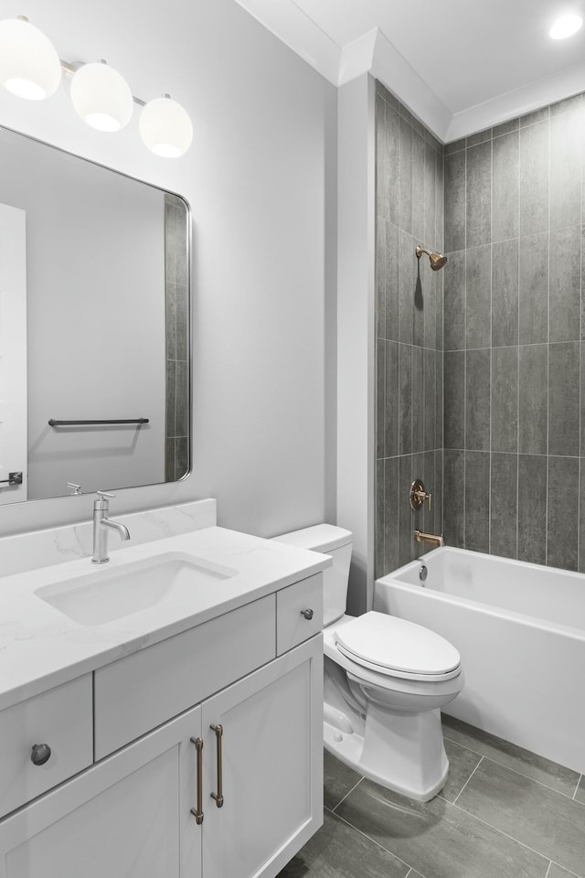 full bathroom with crown molding, vanity, tiled shower / bath combo, and toilet