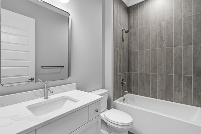 full bathroom with vanity, tiled shower / bath combo, and toilet