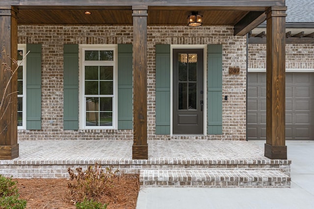 view of exterior entry with a porch