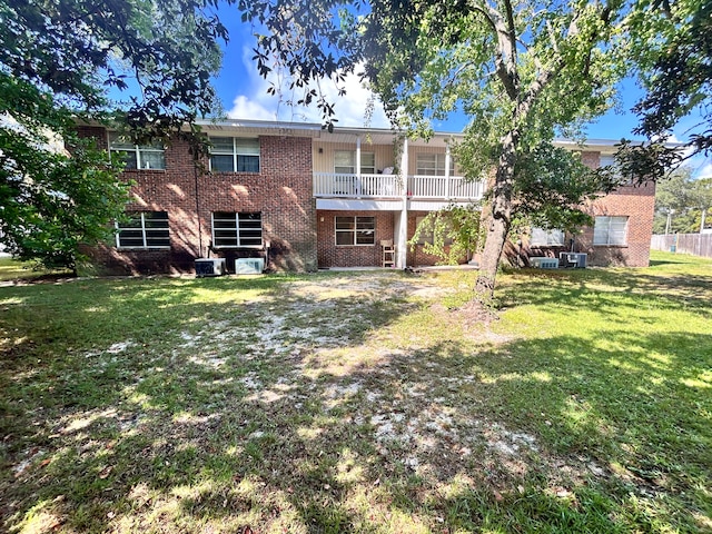 rear view of property featuring a yard