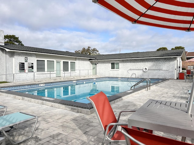 view of swimming pool with a patio