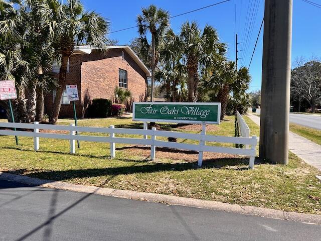 609 Colonial Dr Unit 4, Fort Walton Beach, FL 32547 - community / neighborhood sign featuring fence and a lawn