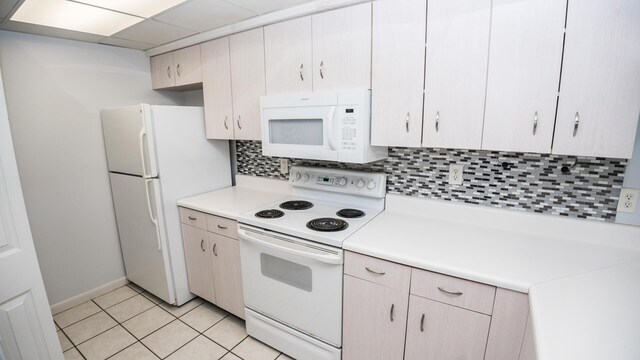 kitchen with white appliances, light tile patterned floors, and decorative backsplash