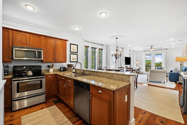 kitchen featuring kitchen peninsula, sink, appliances with stainless steel finishes, and french doors