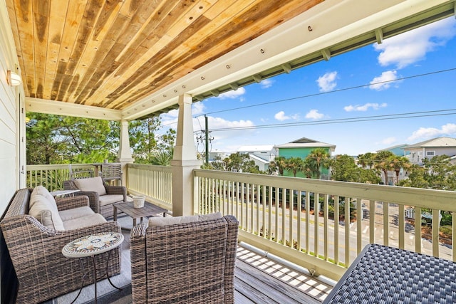 wooden terrace featuring an outdoor living space